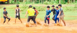 Students and principal play football outdoor at the best school in Calicut the Oxford School Calicut